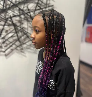 Woman with caramel and blonde ombre curly braids