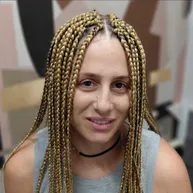 Golden blonde box braids with a center part