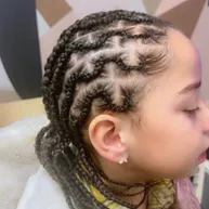 Child's cornrows with a geometric parting pattern