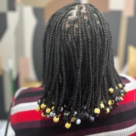 Long knotless box braids with colorful beads at the ends