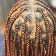 Close-up of a copper-toned cornrow starburst pattern