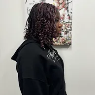 Small braids with a pink tint and curly ends