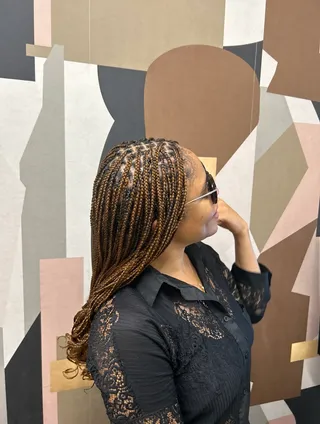 Jennifer Anekwe wearing braids with beaded accents
